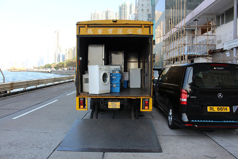 appliances inside an open moving truck parked on the side of the road