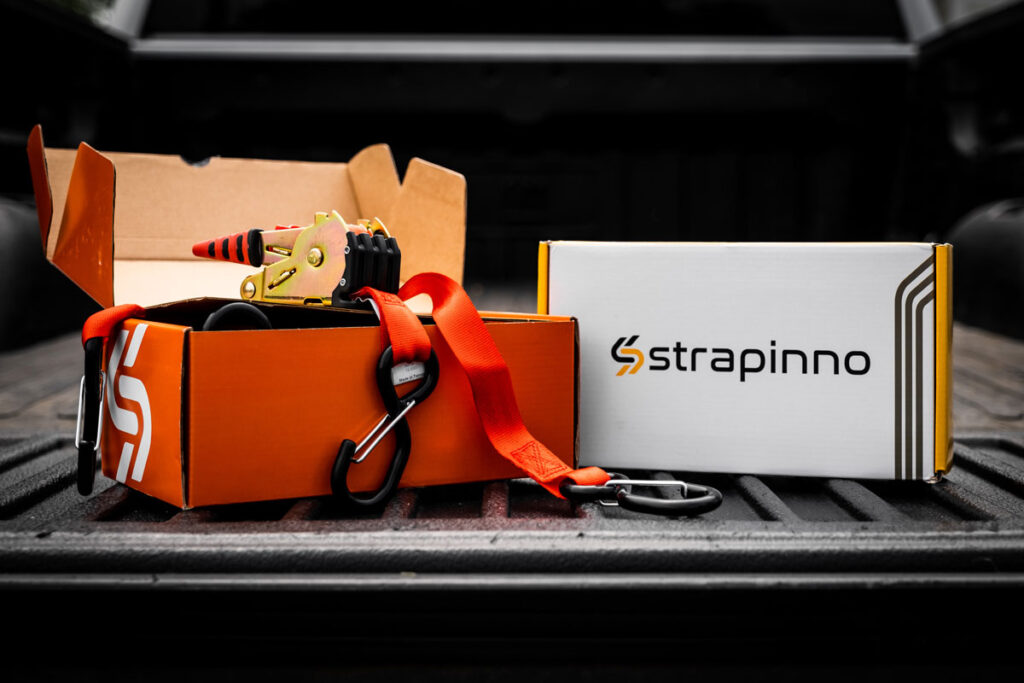 Strapinno retractable ratchet straps and box on the trailer of a pickup truckf