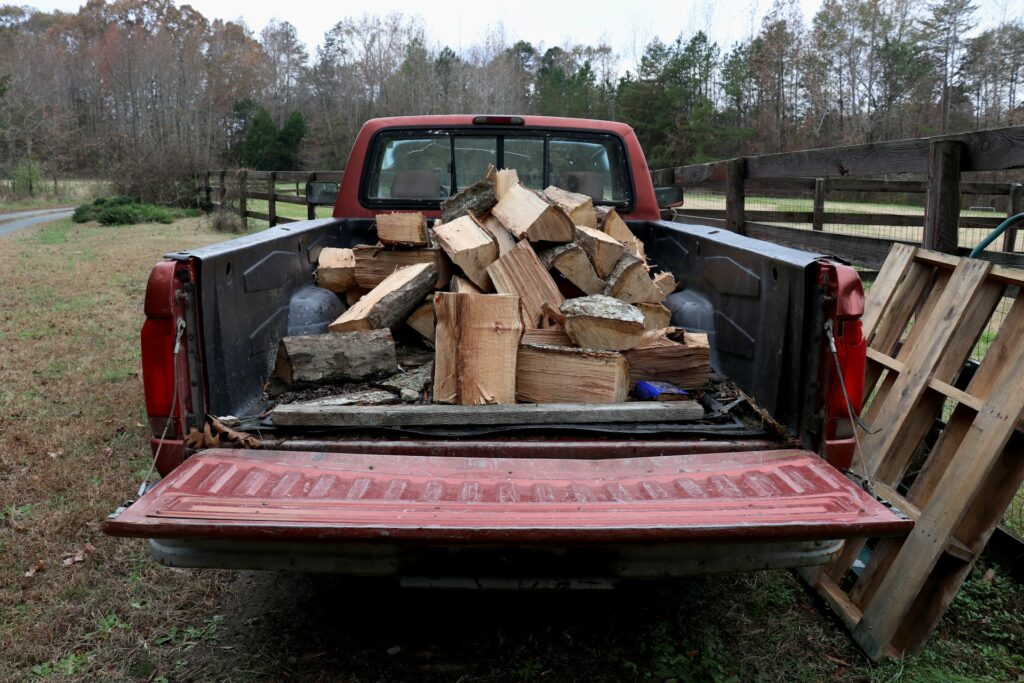 An old pickup truck loaded down with firewood