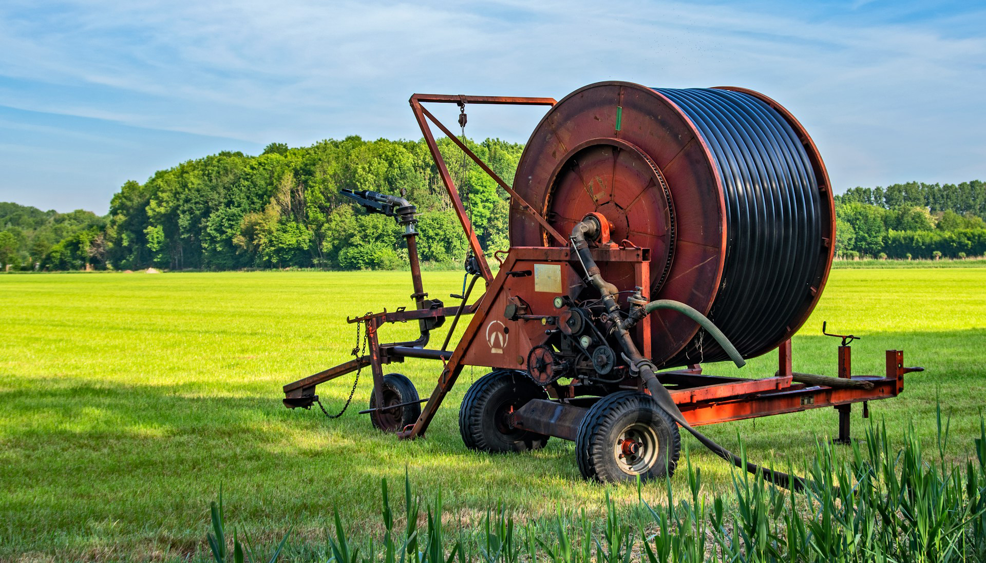 brown and black tractor on green grass field during daytime